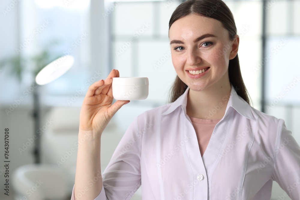 Cosmetologist with cosmetic product in modern clinic Cosmetologist with cosmetic product in modern clinic