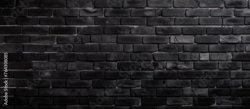 A black brick wall is prominently featured with a solid black background for a stark contrast