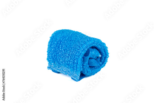 A coiled blue sponge made of polypropylene thread on a white background.