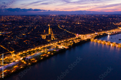 Picturesque view from drone of illuminated modern cityscape of French port city of Bordeaux on river Garonne and Stone Bridge © JackF