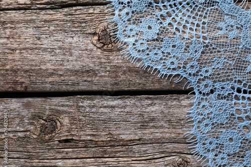 Beautiful lace on wooden table, top view. Space for text