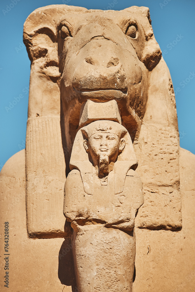 Ram Headed Sphinx. Sculpture of sphinx-ram. Statue of mythical animal and figure of pharaoh. Egypt, Luxor. Vacation destination. Historic site