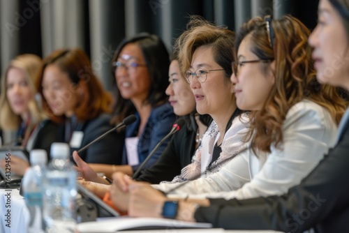 Women participants listening attentively at a business conference panel discussion