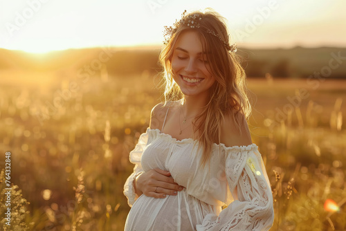 Young Caucasian pregnant woman wearing a white dress, natural rural blurred background, sunset