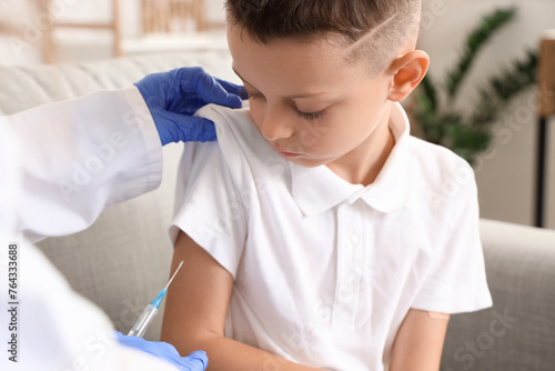 Ill little boy with doctor ...