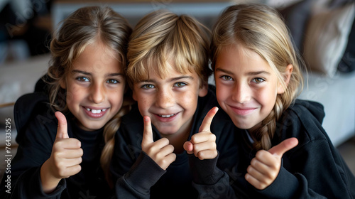 Group of young girls standing next to each other holding their thumbs up.