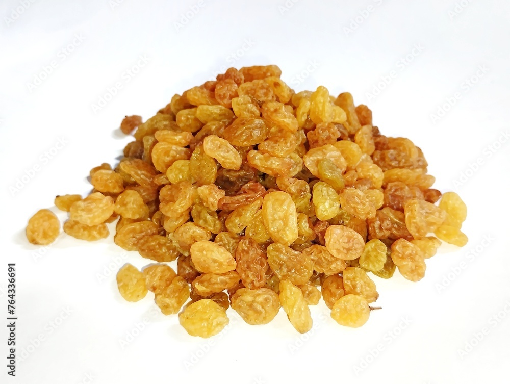 Currant fruit on a white background. Pile the dried raisins on a clear plate Currant fruit on a white background. Pile the dried raisins on a clear plate