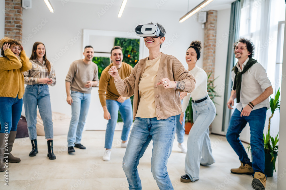 One woman in front group of friends enjoy virtual reality VR headset One woman in front group of friends enjoy virtual reality VR headset