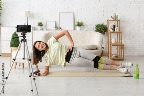 Young woman recording onlin...