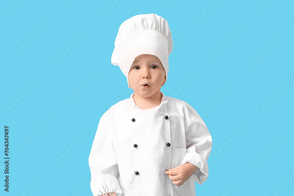 Cute little chef in uniform on blue background Cute little chef in uniform on blue background