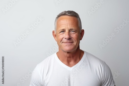 Portrait of a handsome mature man on grey background. Mature man.