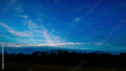 Cloudy morning sunrise in a tall grassy meadow