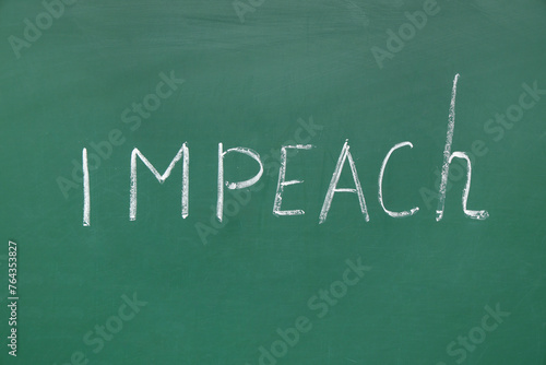 Word IMPEACH written on chalkboard photo