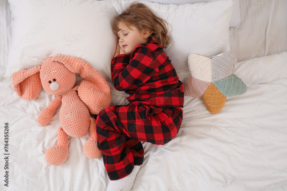 Adorable little girl with plush bunny sleeping in bed Adorable little girl with plush bunny sleeping in bed