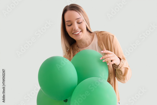 Young woman with balloons o...