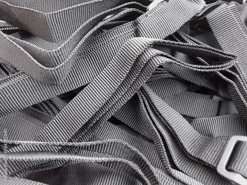 pile of rough textured gray rope. close up of lanyard. bag strap photo