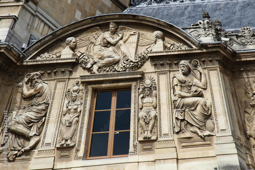 Some architectural details of the building that houses the Louvre museum in Paris, France, one of the most famous museums in the world