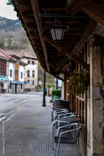 Authentic village ambiance: café terraces, cobblestone streets Cabrales Asturias renowned gastronomy