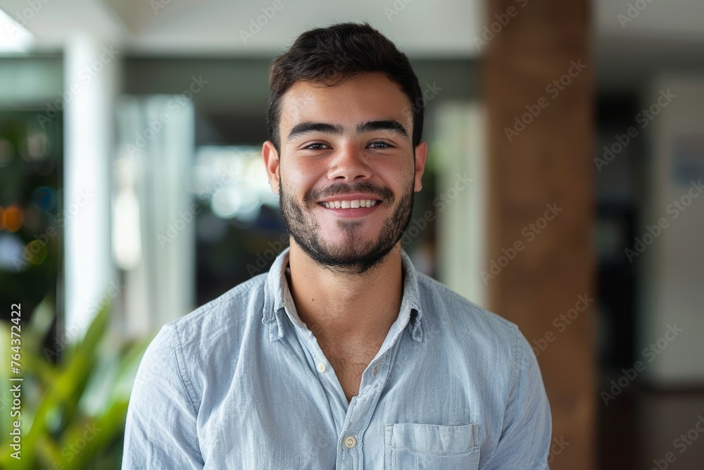 A man with a beard and a smile is wearing a blue shirt A man with a beard and a smile is wearing a blue shirt