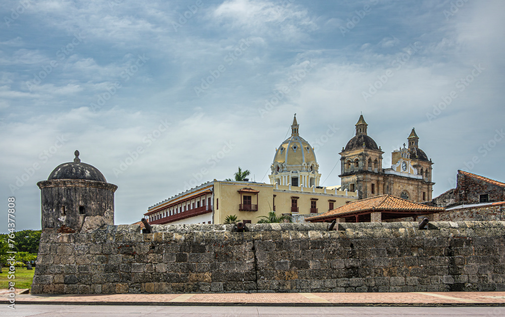 Cartagena, Colombia - July 25, 2023: Baluarte de San Ignacio and Santuario de San Pedro Claver under blue cloudscape seen from Avenida Blaz de Lezo