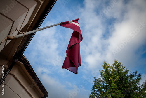 Selective blur on a latvian flag waiving in the sky in Riga. The flag of Latvia, or Latvijas karogs, is the national symbol of the republic of Latvia.