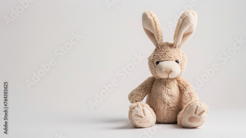 toy Easter Bunny with bow and Easter Eggs over white background. Area for text and images to left. Happy Easter Card