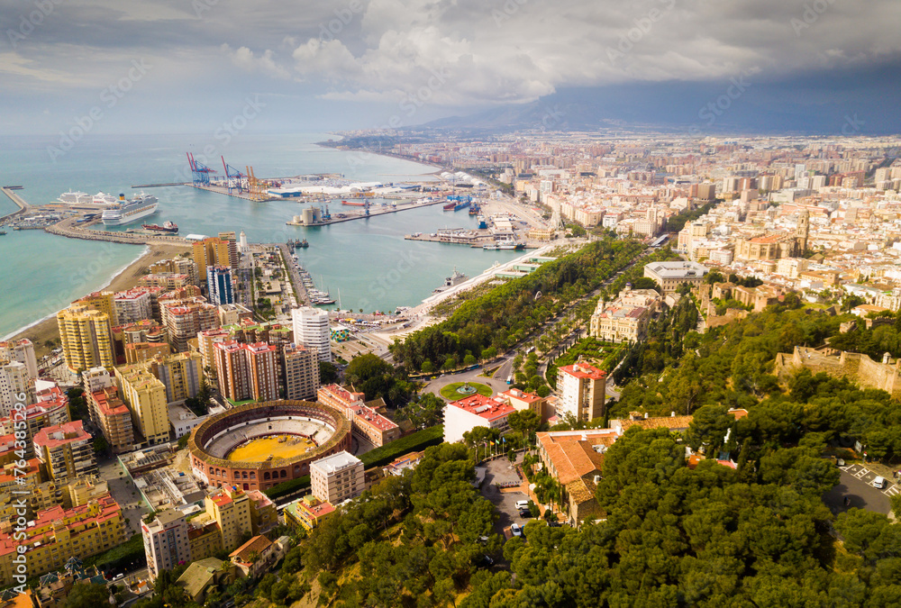 Aerial cityscape of spanish city Malaga with port and bullring