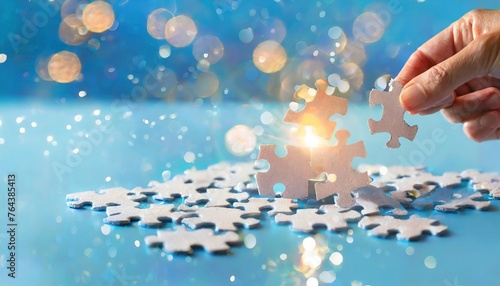 Hand Completing Jigsaw Puzzle on Blue Background