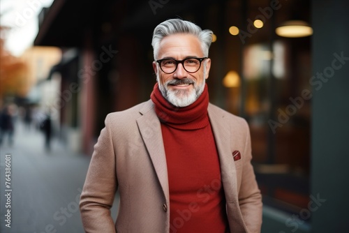 Portrait of a handsome senior man wearing coat and eyeglasses