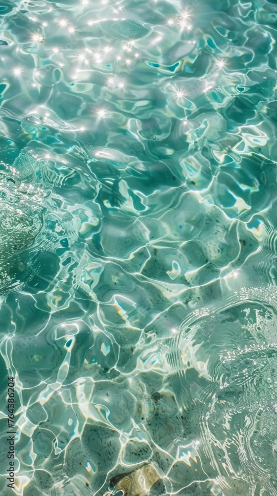 Top view of calm and clean blue and green water with reflections of the sun Top view of calm and clean blue and green water with reflections of the sun