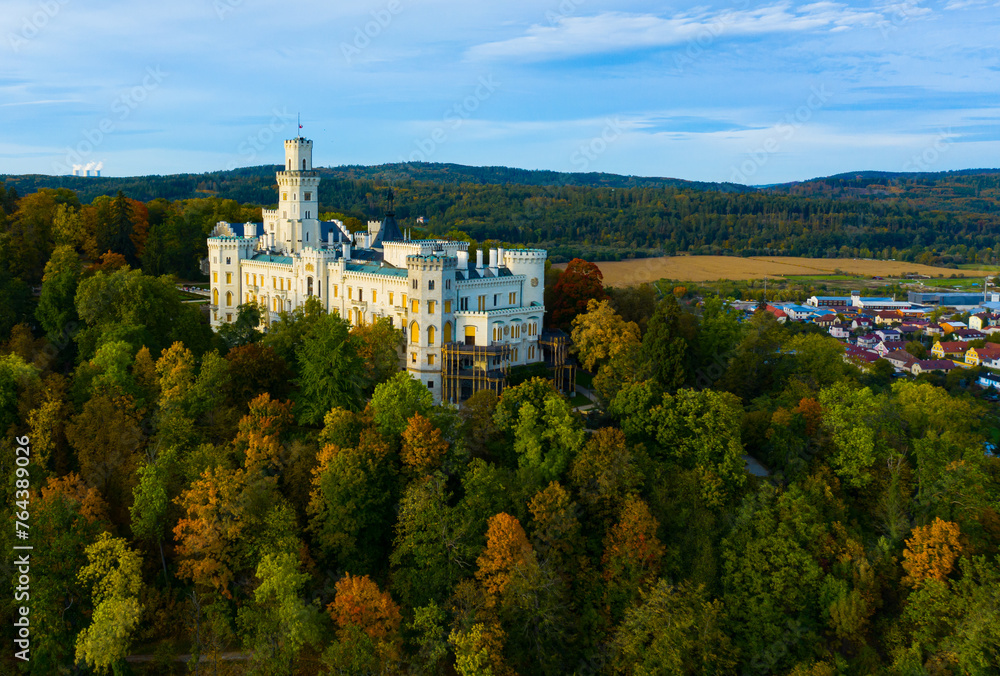 Aerial view of medieval Hluboka nad Vltavou castle in green and yellow autumn park, Czech Republic