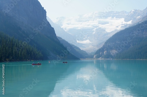Brilliant turquoise waters of Lake Louise, Alberta with a backdrop of majestic mountains and glaciers on a sunny autumn day