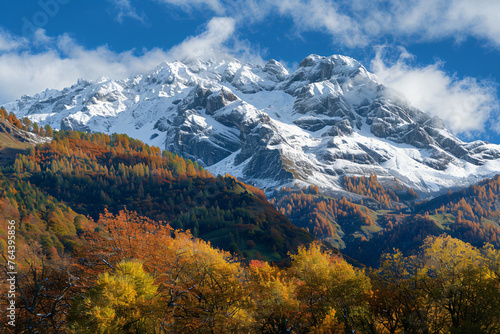 Photo of the Alps with snow on top, a mountain range in Italy, trees and shrubs below, nature photography, autumn colors, high resolution, neutral sky background