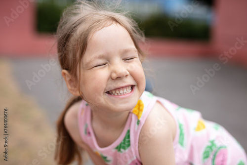 Cute little girl laughing and making faces