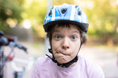 Young boy in helmet making faces photo