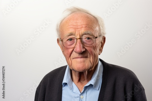 Portrait of an old man with glasses on a white background.