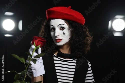 Photos Young woman in mime costume with red rose performing on stage