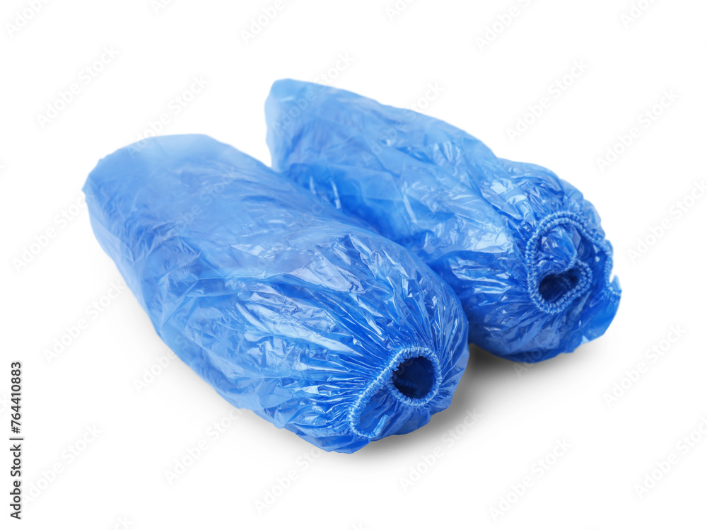 Fototapeta premium Rolled blue shoe covers isolated on white