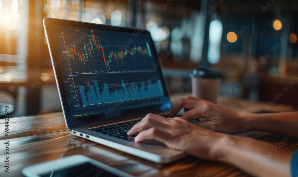 Laptop screen displaying stock market data - An individual analyzing financial graphs and statistics on a laptop screen at a modern workspace Laptop screen displaying stock market data - An individual analyzing financial graphs and statistics on a laptop screen at a modern workspace