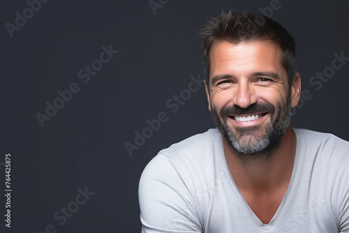 charming smiling man portrait isolated on gray © alisaaa