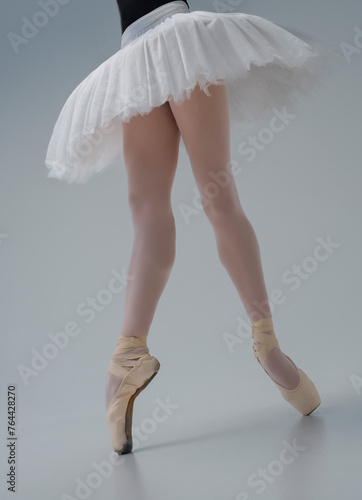 photo of a ballerina's legs in pointes showing a pa during a performance