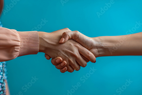 Hands in handshake, symbolizing friendship, cooperation, and successful agreements
