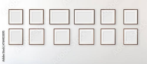 A wall adorned with numerous unfilled picture frames for displaying artwork or photographs