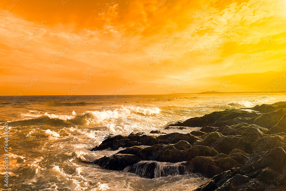 Naklejka premium Landscape view of golden sunset, evening sunlight over the ocean coastline headland.
