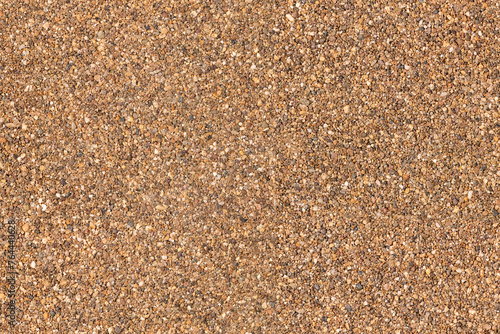 An aerial view of a large, stony surface ground texture. Image is ready to be tiled to create a much larger image or higher resolution background of a detailed sandy pebble aggregate floor.