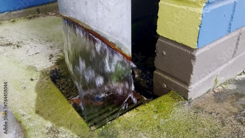 4K vide of  during a heavy rainfall event with the massive runoff pouring into a pipe stormwater drain system photo