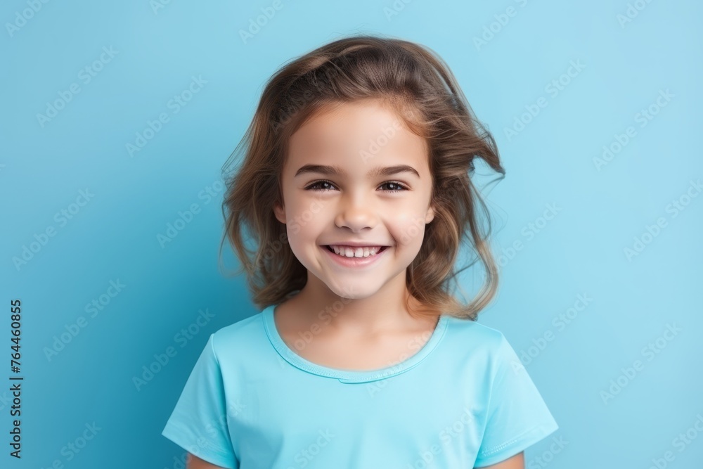 Portrait of a smiling cute little girl on a blue background. Portrait of a smiling cute little girl on a blue background.