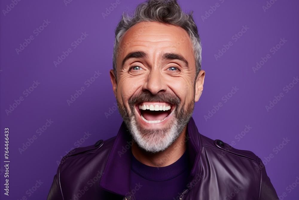 Portrait of a happy mature man with beard and mustache. Isolated on purple background. Portrait of a happy mature man with beard and mustache. Isolated on purple background.