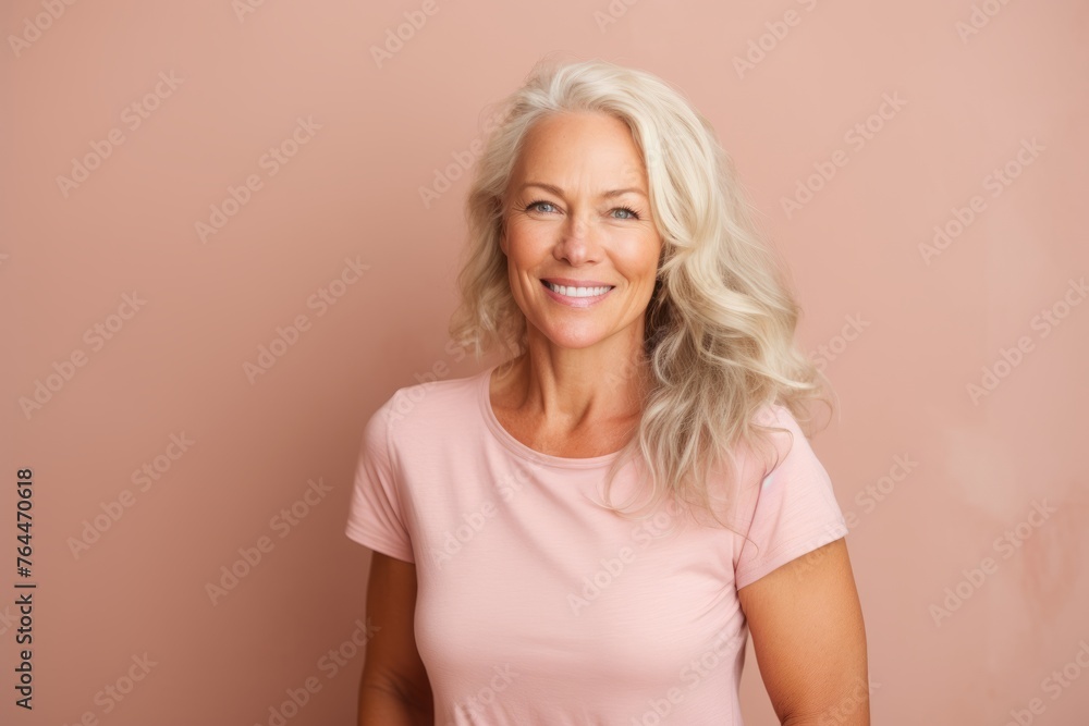 Portrait of a beautiful middle-aged woman on a pink background Portrait of a beautiful middle-aged woman on a pink background