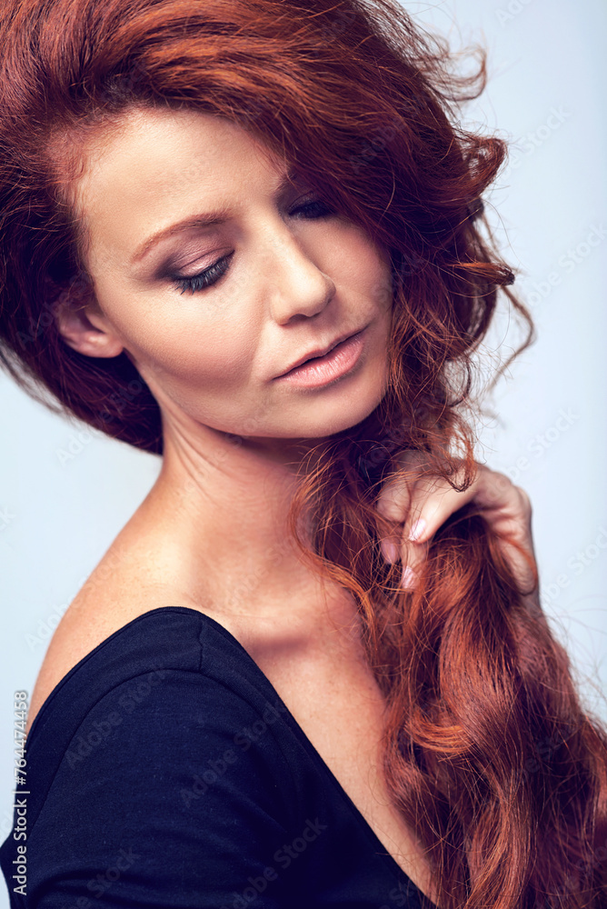 Fototapeta premium Beauty, relax and woman in studio with haircare, natural keratin glow and healthy hairstyle. Growth, shine and confident girl with red hair, wellness and luxury salon treatment on blue background